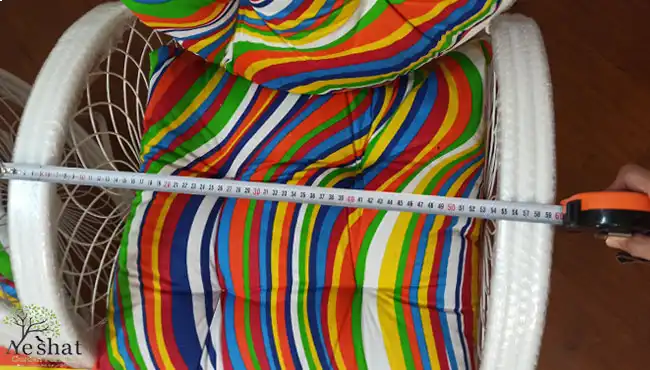 اندازه‌گیری عرض تشک پشتی صندلی باغی با پارچه رنگین‌کمانی راه‌راه (قرمز، زرد، آبی، سبز)، عرض حدود ۵۵ سانتی‌متر - گالری نشاط